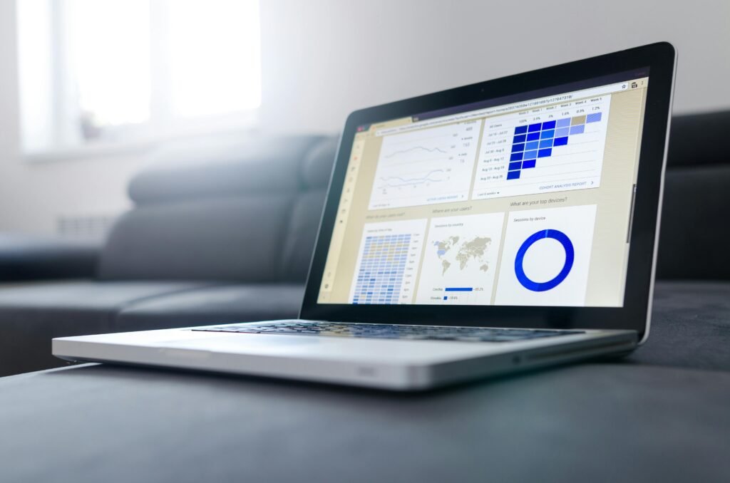 Sleek laptop showcasing data analytics and graphs on the screen in a bright room.digital marketer in kasaragod